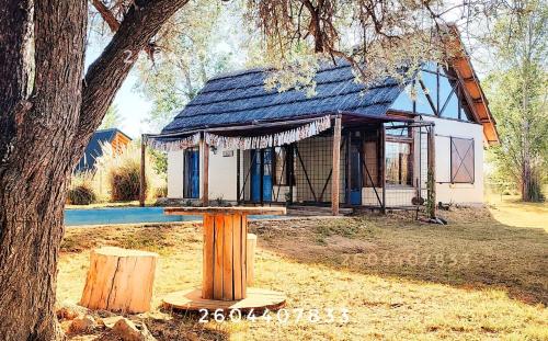 a small house with a tree in front of it at Cabaña de Pez in San Rafael