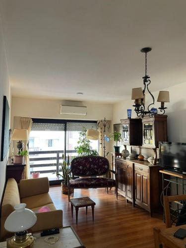 a living room with a couch and a table at Departamento Zona centro con cochera in Mar del Plata