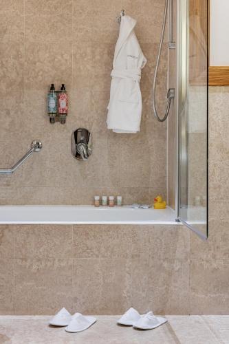 a bathroom with a shower and a bath tub at Starhotels Anderson in Milan
