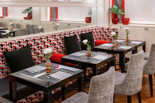 a row of tables and chairs in a restaurant at Starhotels Anderson in Milan