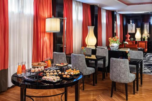 a room with a table with food on it at Starhotels Anderson in Milan