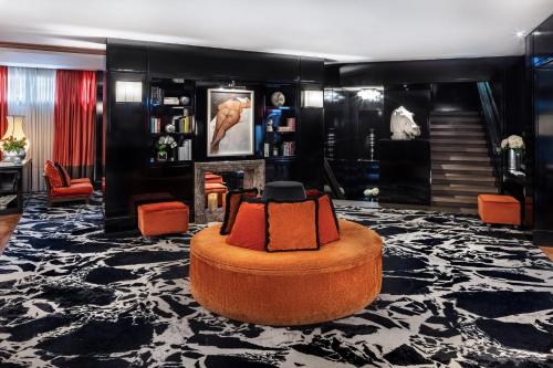 a living room with a chair and a fireplace at Starhotels Anderson in Milan