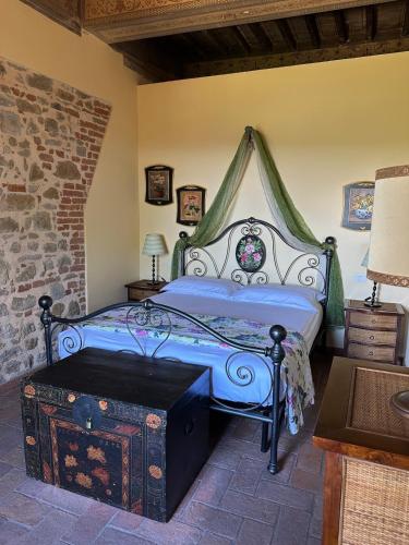 a bedroom with a bed with a canopy at La Casina di Pinutte in Campagnatico