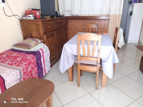 a dining room with a table and a chair at IVATO Airport STUDIOS CHAMBRES in Ivato