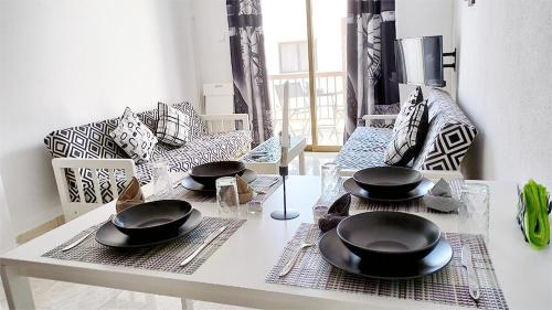 a dining room table with black dishes on top of it at SPECIAL OFFER -70 Percent OFF - Sleep 5 - Best Location - Free Parking in Ayia Napa