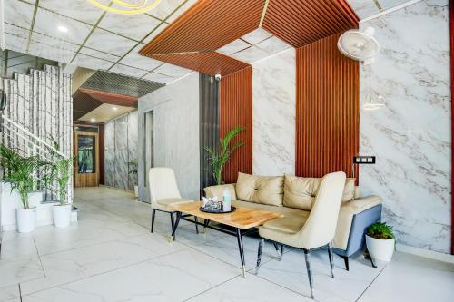 a living room with a couch and a table at Hotel O Platinum in Zirakpur