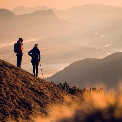 two people walking up a hill on a mountain at Ferienhotel Sonnenhof in Zell am Ziller