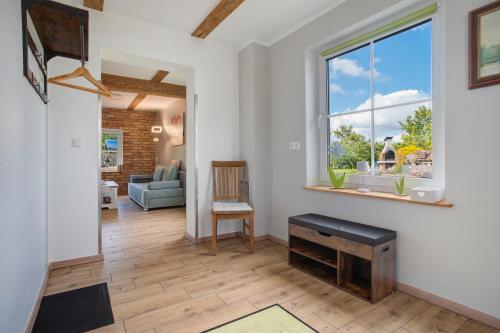 a living room with a window and a chair at Ferienwohnung Uschi 