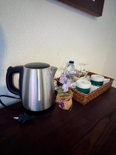 a coffee pot and a basket of dishes on a table at Casa da Quinta De S. Martinho in Vila Real