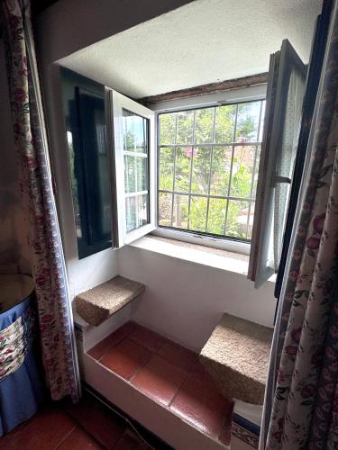 an empty room with a window and some stairs at Casa da Quinta De S. Martinho in Vila Real