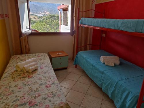 Ένα ή περισσότερα κρεβάτια σε δωμάτιο στο Orizzonte Sardo