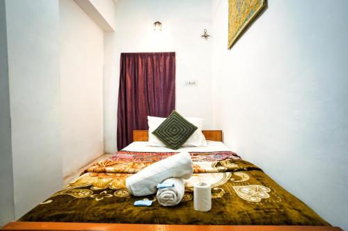 a hotel room with a bed with towels on it at Hotel The Surya Jaisalmer in Jaisalmer