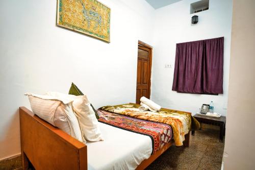 a hotel room with a bed and a window at Hotel The Surya Jaisalmer in Jaisalmer