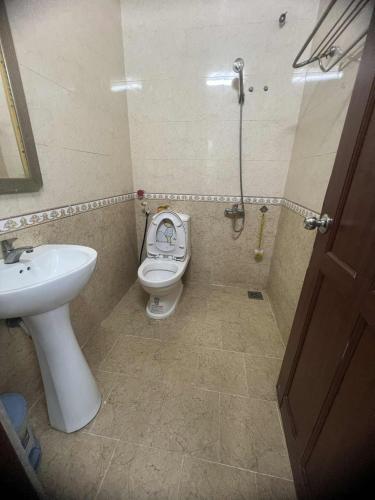a bathroom with a toilet and a sink at hotel đặng hiền lương in Ho Chi Minh City