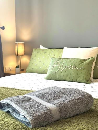 a bedroom with a bed with a pillow with the word bloom on it at Jambow Blue in Filey