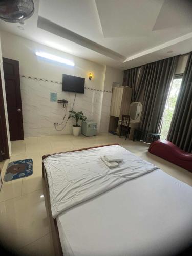 a bedroom with a bed with a white shirt on it at hotel đặng hiền lương in Ho Chi Minh City
