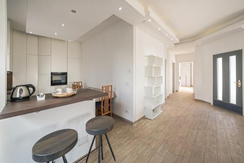 a kitchen with two stools and a counter top at Casa Panoramica - Via Belvedere in Cavallasca
