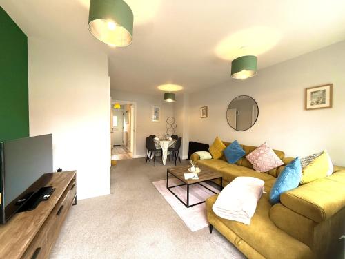a living room with a couch and a table at Jambow Blue in Filey