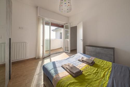 a bedroom with a bed with two towels on it at Casa Panoramica - Via Belvedere in Cavallasca