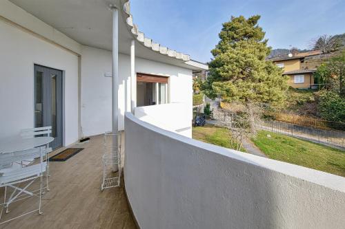 a balcony of a house with a table and chairs at Casa Panoramica - Via Belvedere in Cavallasca