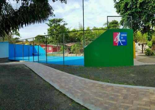 a batting cage in a park with a fence at Forest 15 min from Manta Beach in Pacoche
