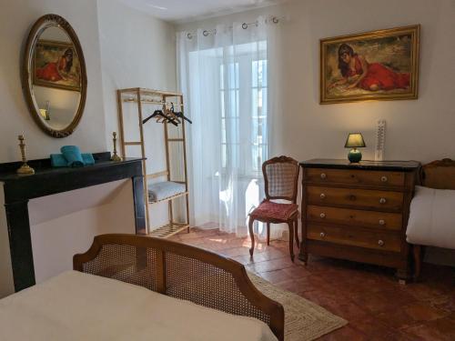 a living room with a dresser and a mirror at La maison Vigneronne de Ferdinand à 8mn de Carcassonne in Rouffiac-dʼAude