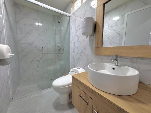 a bathroom with a sink and a toilet and a mirror at Forest 15 min from Manta Beach in Pacoche