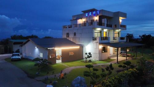 a house with a sign on top of it at night at Zhitian Heye in Chenggong