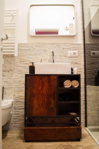 a bathroom with a sink and a mirror at Qt suite & luxury in Rome