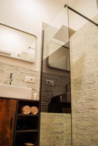 a bathroom with a shower with a sink and a mirror at Qt suite & luxury in Rome