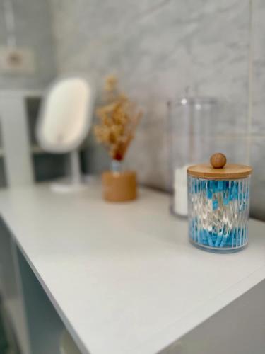 a white counter top with a cup and a plant on it at Casa Rosmarino in Carbonia