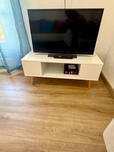 a flat screen tv on a white entertainment center at Casa Rosmarino in Carbonia