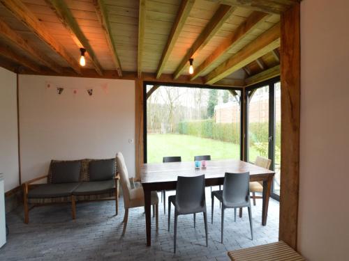 a dining room with a table and chairs at Cozy Holiday Home in Aalter near Lake in Maria Aalter
