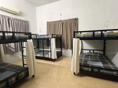 a room with three bunk beds in it at The Eighty8 PP in Phnom Penh