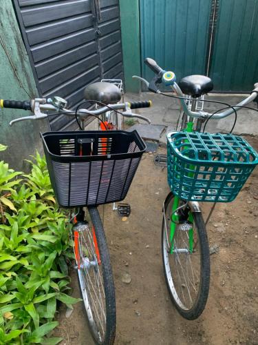 due biciclette parcheggiate l'una accanto all'altra con un cesto di The Orange House Weligama a Weligama