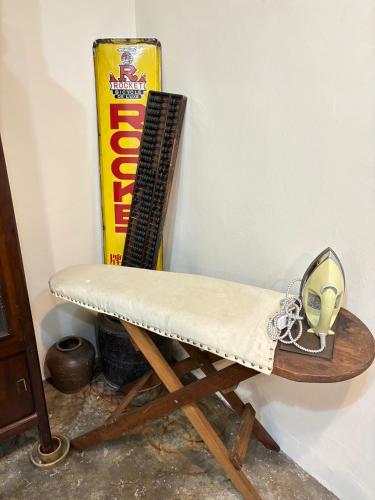 a chair sitting in a corner next to a box at KY Homestay in Gua Sai