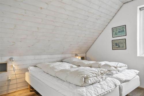a room with four pillows lined up in a attic at 0371-Romo-Sonder-Frankel-4 in Havneby