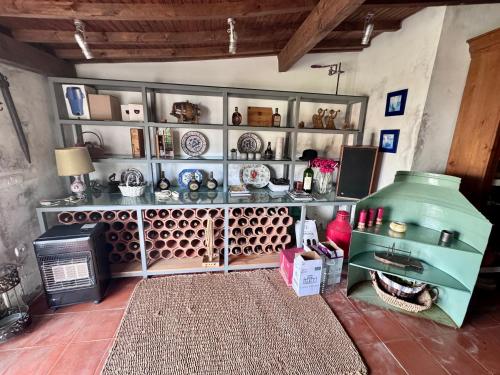 a room with a stove and shelves with dishes at Casa da Quinta De S. Martinho in Vila Real