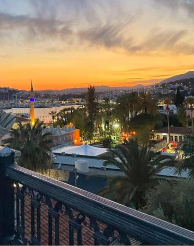 a view of a city at sunset from a balcony at Casa Roma Boutique Hotel in Bodrum City
