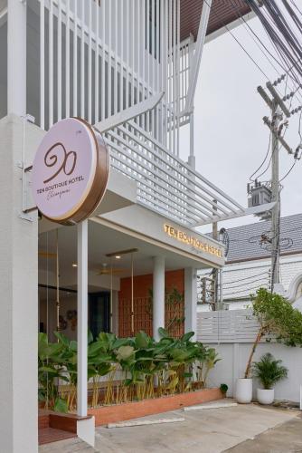 a building with a sign in front of it at Ten Boutique Hotel Oldtown Chiangmai in Chiang Mai