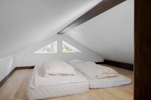 a bedroom with two white beds in a attic at 0660-Toftlund-Vestskoven-8 in Toftlund