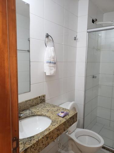 a bathroom with a sink and a toilet and a shower at Apto Cittá in Brasília