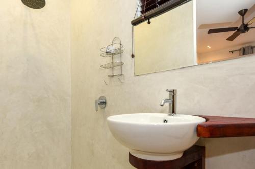 a bathroom with a white sink and a mirror at Lembah Kali Riverside Estate by Euphoric Leisure in Lanseria