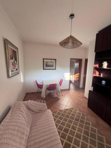 a living room with a table and a couch at Casa da Quinta De S. Martinho in Vila Real