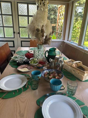 a table with plates of food on top of it at Teeveere Summer House in Treimani