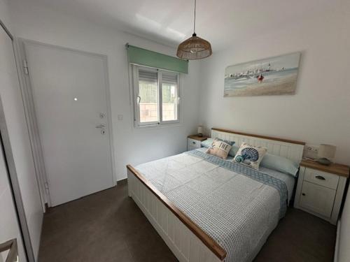 a bedroom with a bed and a picture of a beach at Beach House Renata in Gran Alacant
