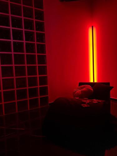 a red room with a bed and a lamp at Qt suite & luxury in Rome