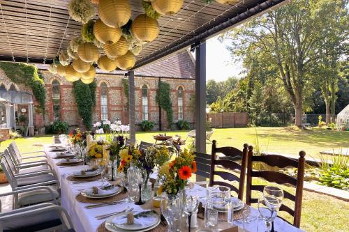 a long table with flowers on it in a garden at The Chapel in North Elmham