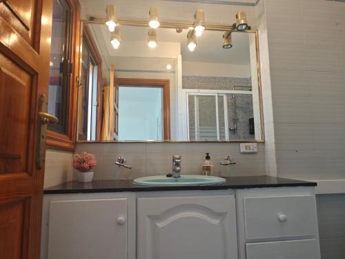 a bathroom with a sink and a mirror at Casa Quico in Santa Cruz de Tenerife