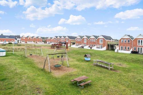 a park with a playground with benches and houses at 0456-Romo-Vestergade-227-Ap-15 in Sønderby